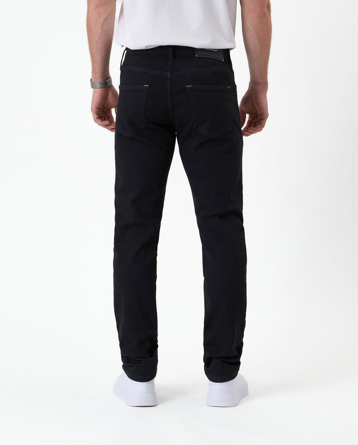 The Jeans Slim Fit in Jet Black — back view showing the slim silhouette