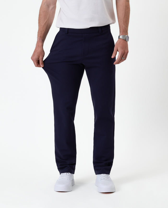 The Proper Pant Regular Fit in navy — showing the four-way stretch fabric