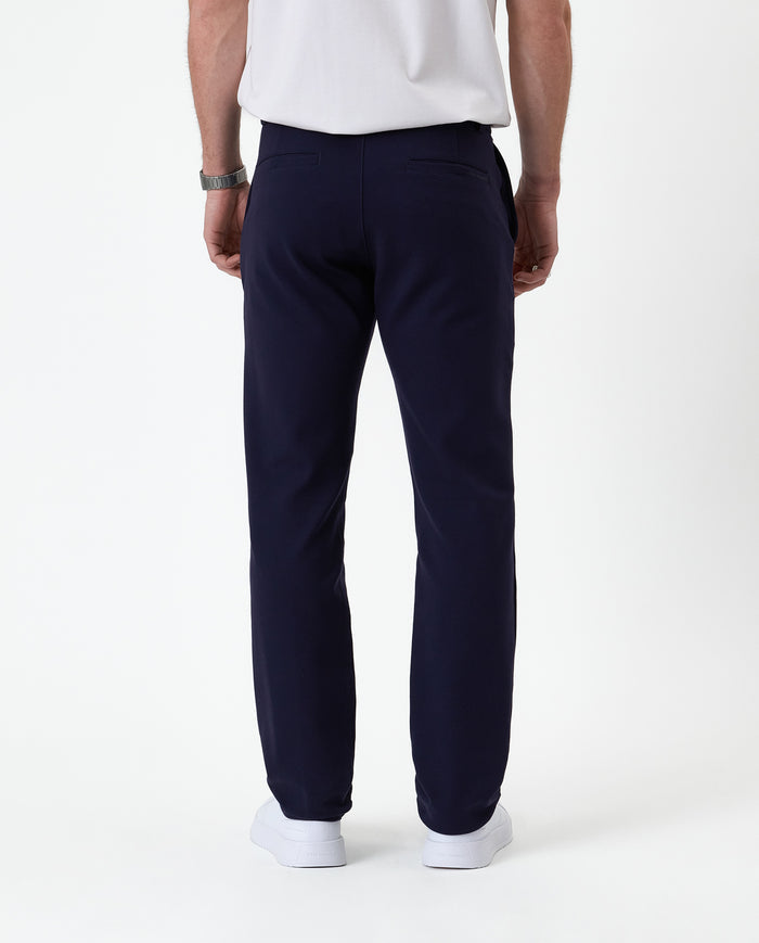 The Proper Pant Regular Fit in navy — back view showing the welt pockets and straight leg