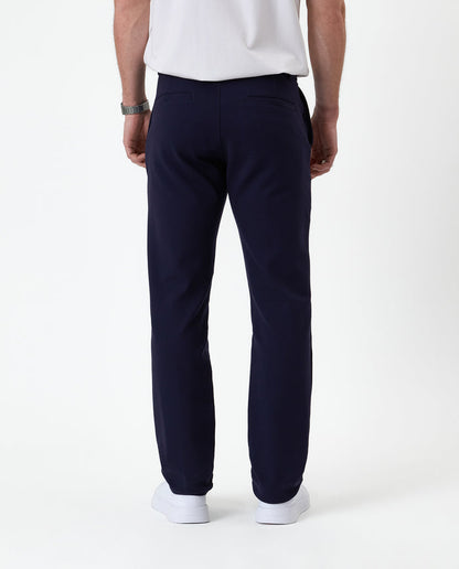 The Proper Pant Regular Fit in navy — back view showing the welt pockets and straight leg