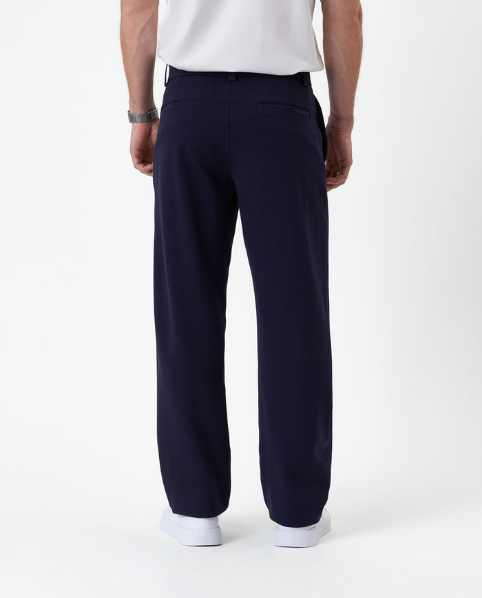 The Proper Pant Relaxed Straight Fit in navy — back view showing the relaxed silhouette