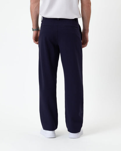 The Proper Pant Relaxed Straight Fit in navy — back view showing the relaxed silhouette