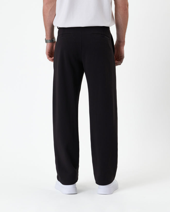 The Proper Pant Relaxed Straight Fit in black — back view showing the straight leg silhouette