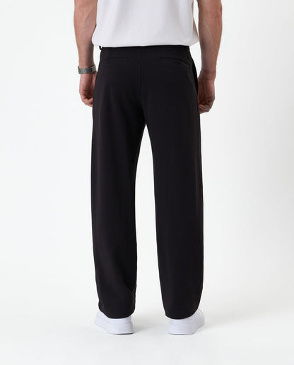 The Proper Pant Relaxed Straight Fit in black — back view showing the straight leg silhouette