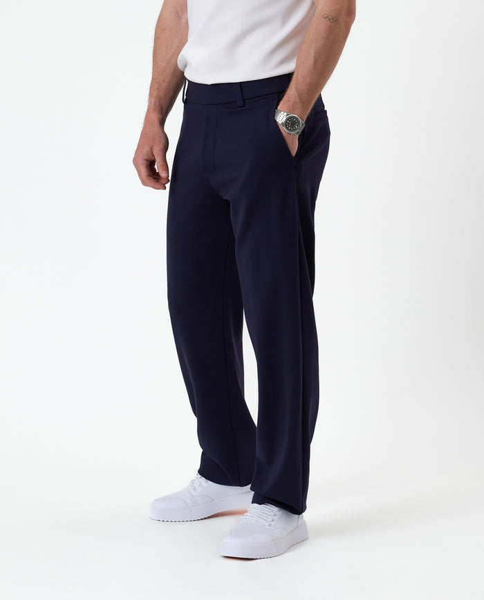 The Proper Pant Relaxed Straight Fit in navy — worn with white sneakers