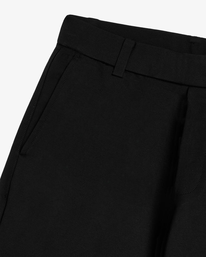 The Proper Pant Relaxed Straight Fit in black — close-up of the waistband and side pocket