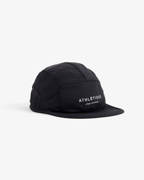 A front angled view of The Running Cap in black, placed on a white background. The image highlights the perforated mesh side panels and the reflective ATHLÉTIQUE and c'est normal logo on the front.