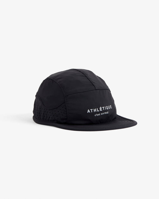 A front angled view of The Running Cap in black, placed on a white background. The image highlights the perforated mesh side panels and the reflective ATHLÉTIQUE and c'est normal logo on the front.