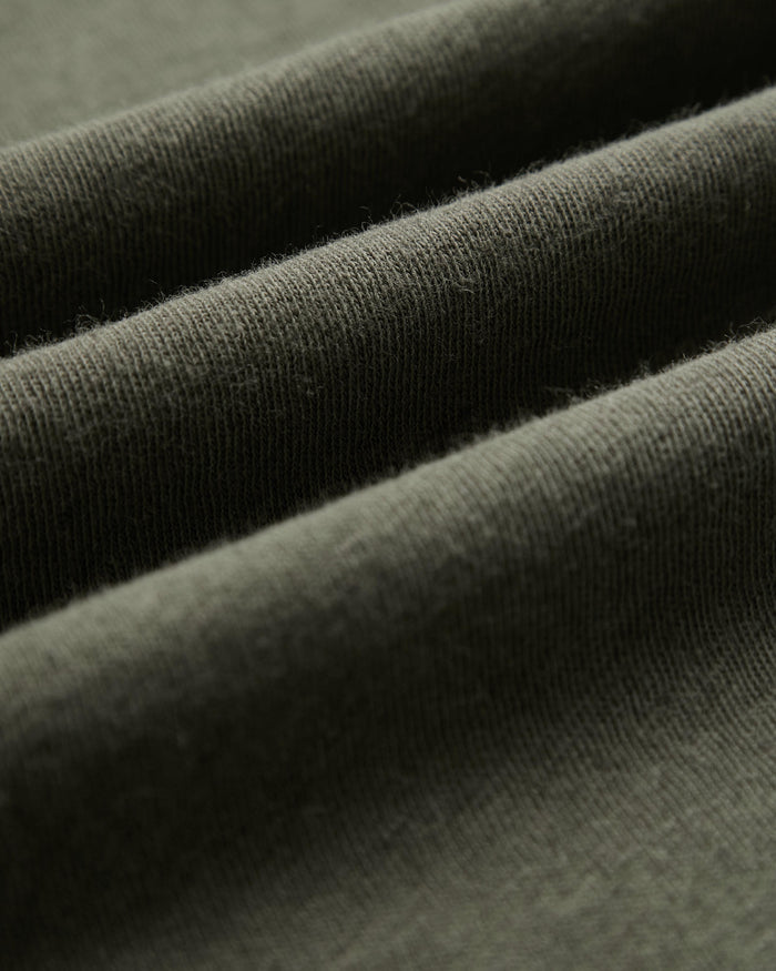 The Sanremo Linen Tee in Mulled Green — close-up of the textured linen-cotton jersey fabric