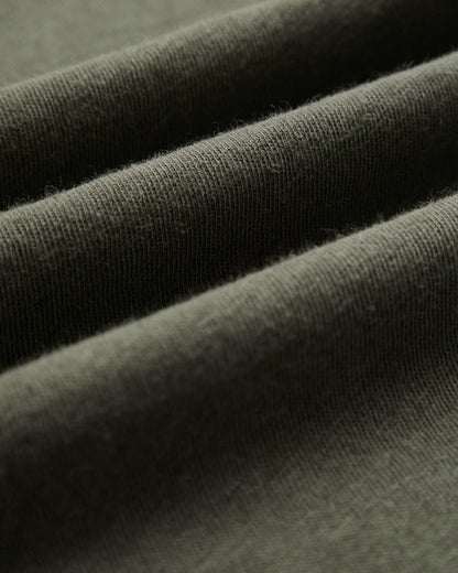 The Sanremo Linen Tee in Mulled Green — close-up of the textured linen-cotton jersey fabric