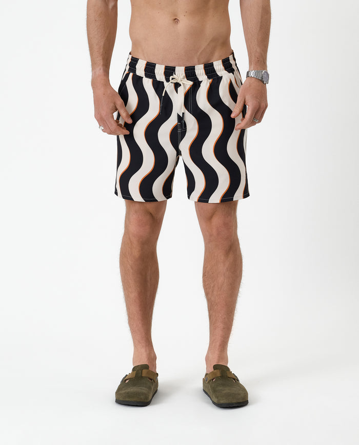 The Shorts in noir curl stripe — front view showing the wavy pattern and orange accents