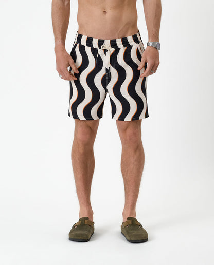 The Shorts in noir curl stripe — front view showing the wavy pattern and orange accents
