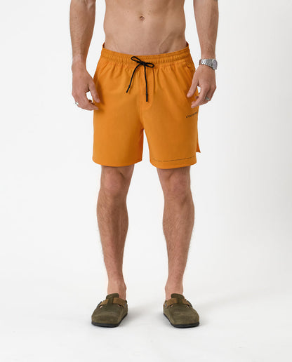 The Shorts in orange peel — front view with black drawstring and C'est normal logo