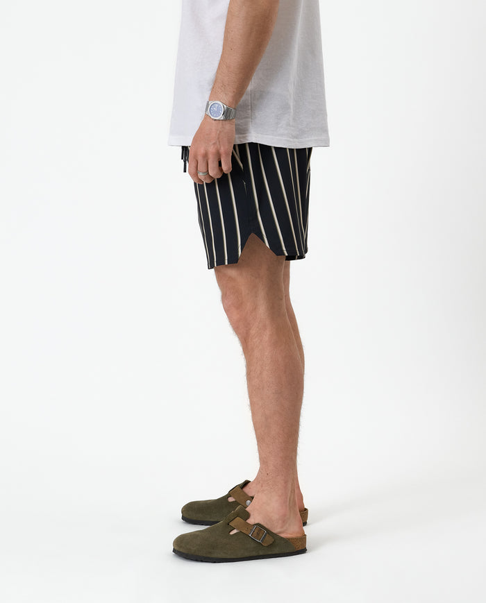 The Shorts in Noir Stripe — side view showing the notched hem and vertical stripes