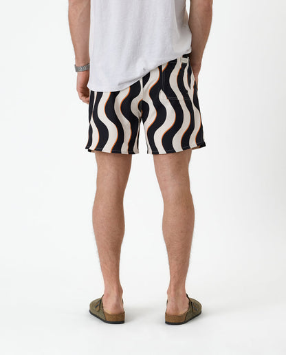 The Shorts in Noir Curl Stripe — back view showing the wavy graphic pattern