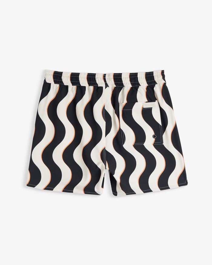 A back view of The Shorts in Noir Curl Stripe, laid flat on a white background. The image highlights the wavy stripe pattern, the elasticated waistband, a back pocket, and the c'est normal logo.
