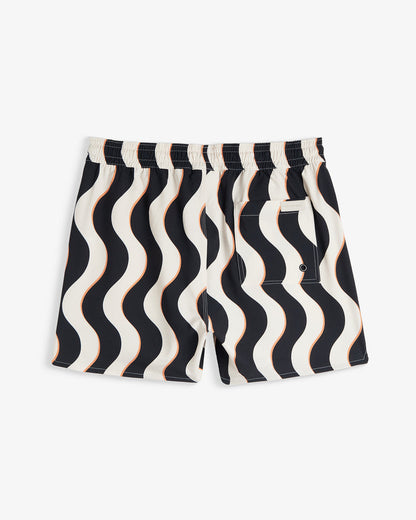 A back view of The Shorts in Noir Curl Stripe, laid flat on a white background. The image highlights the wavy stripe pattern, the elasticated waistband, a back pocket, and the c'est normal logo.
