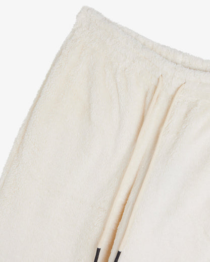 A close-up shot of the soft, fuzzy fabric of The Teddy Pant in cream, highlighting the elasticated waistband and drawstring.