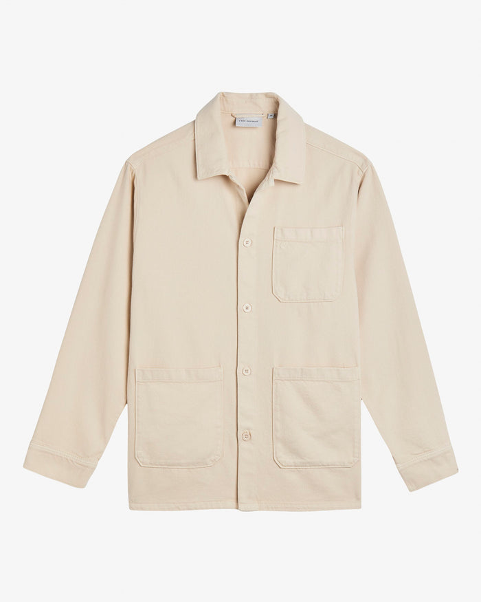 A front view of The Workwear Overshirt in cream, laid flat on a white background. The image highlights the button closures and patch pockets at the left chest and hips.