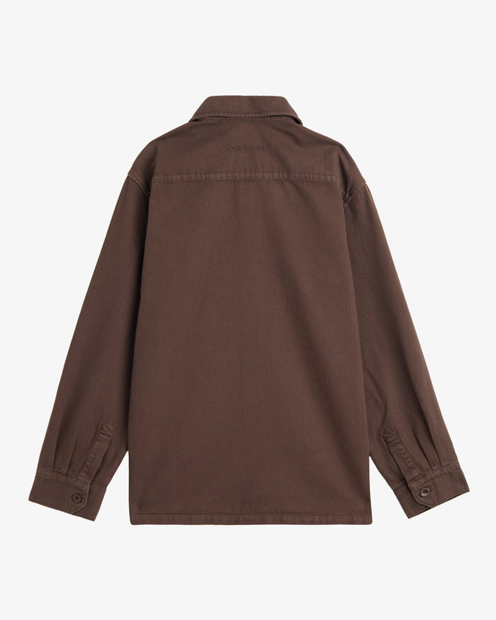A back view of The Workwear Overshirt in brown, laid flat on a white background. The image highlights the tone-on-tone embroidered c'est normal logo on the back.