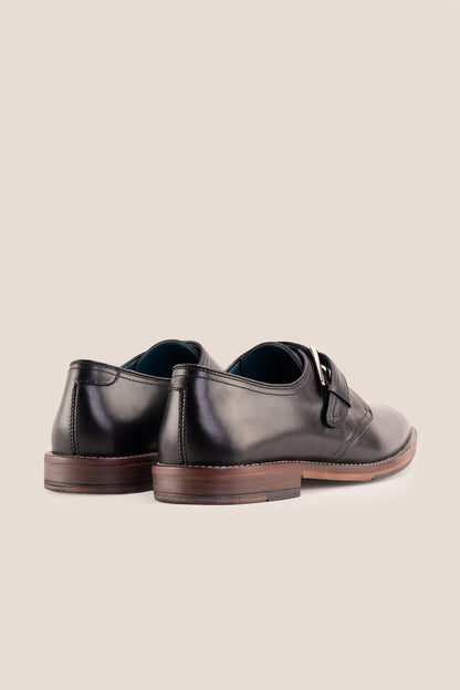Premium men's black leather single monk strap dress shoes by Oswin Hyde London featuring a plain toe, adjustable silver buckle, contrast sole stitching, and a cushioned teal interior.
